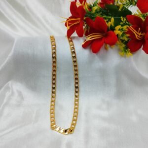 Men's Classic Gold-Tone Figaro Chain from www.radiantjewels.store displayed on white satin with red flowers