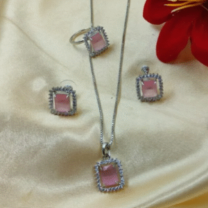 Pink Crystal Pendant Set – Shine in Every Celebration The Pink Crystal Pendant Set from Radiant Jewels is designed for women who love to celebrate every moment in style. This elegant set includes a charming pendant necklace and matching earrings, each adorned with radiant pink crystals that shimmer with every movement. Whether you're attending a wedding, a festive event, or a family function, this set adds just the right amount of glamour. Designed to Dazzle Crafted on a lightweight, skin-friendly alloy, the pendant and earrings are finished in a glossy silver tone. The central focus remains the pink crystal—symbolizing grace, love, and femininity. Thanks to its classic teardrop shape, the pendant rests gracefully on your neckline, making it a versatile match for ethnic and western outfits alike. Style It Your Way Pair this set with a pastel lehenga, anarkali, or even a crisp saree to enhance your festive look. If you prefer minimal styling, just wear the pendant solo—it still makes a statement. You can also explore our crystal earrings collection to mix and match for varied looks. Besides being a treat for yourself, this pendant set is a perfect gifting choice for your sister, friend, or loved one. With its modern yet timeless design, it's ideal for birthdays, Diwali, or Rakhi gifts. ✨ Shop the Radiantjewels.store Exclusive Collection – Where Every Piece Tells a Story!